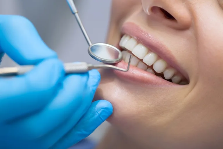 Photo of a Dentist Examining a Patient's Teeth