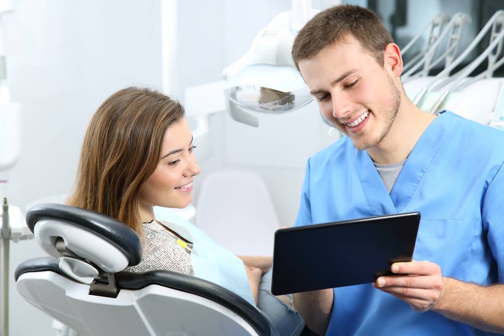 Photo of dentist showing tablet