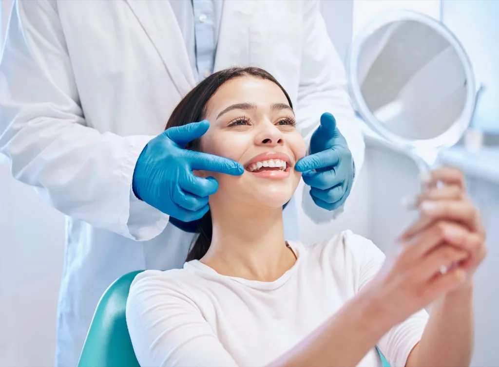 Dentist show their patient the results from a dental procedure